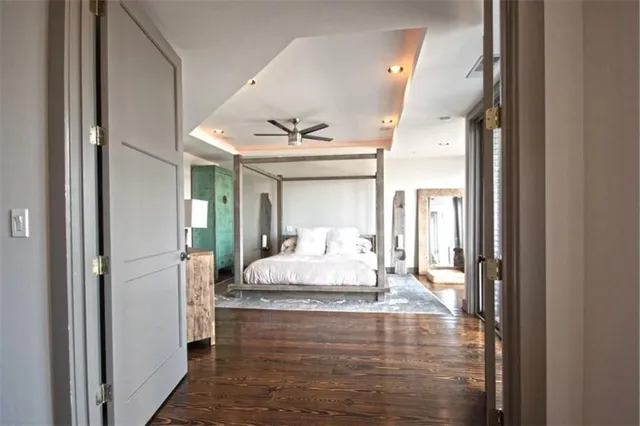 a view of empty room with wooden floor