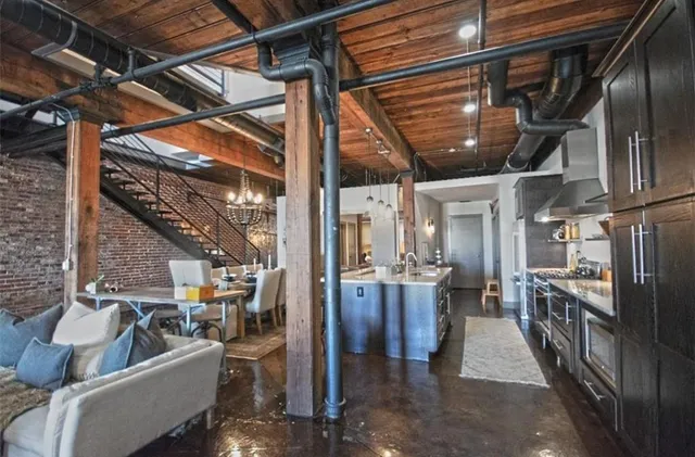 a very nice looking living room with lots of furniture and gym equipment