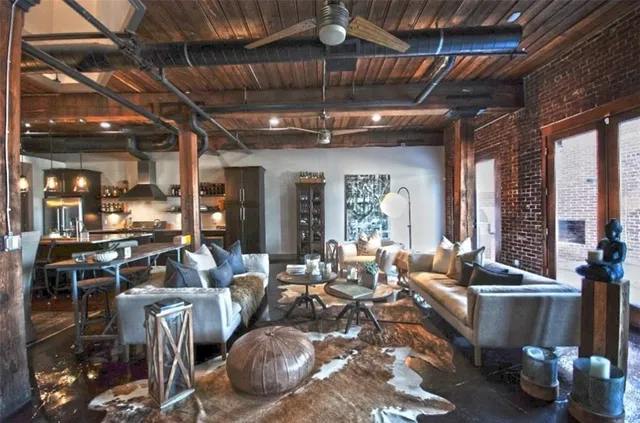a living room with fireplace furniture and a large window