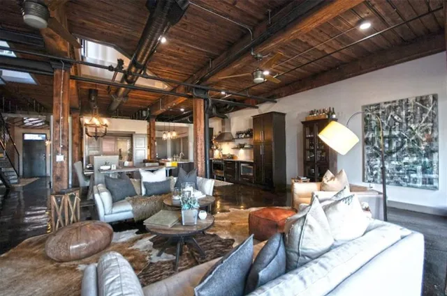 a bedroom with a bed potted plant and windows