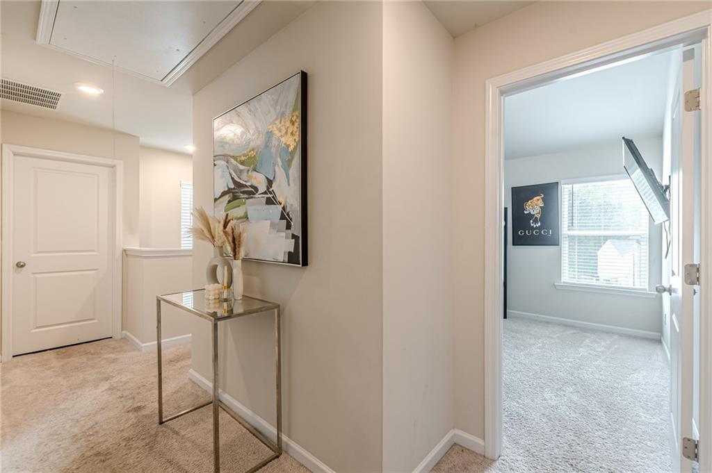 7425 Faith Street Fairburn, GA 30213 - Photo 14 of 29 a view of hallway with windows and chandelier