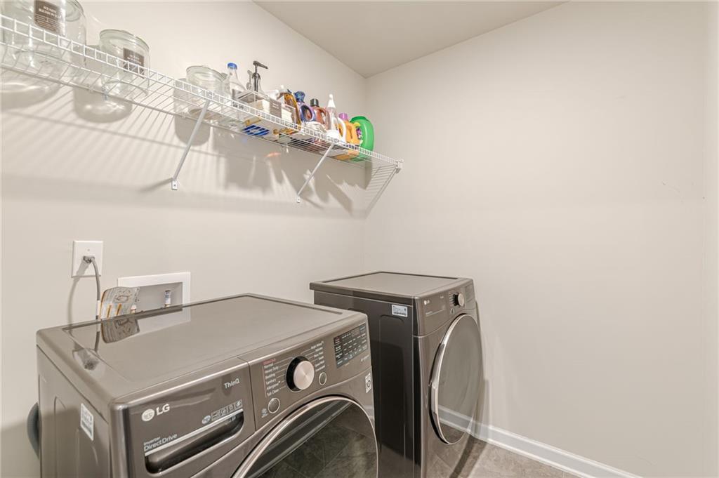 7425 Faith Street Fairburn, GA 30213 - Photo 15 of 29 a utility room with dryer and washer
