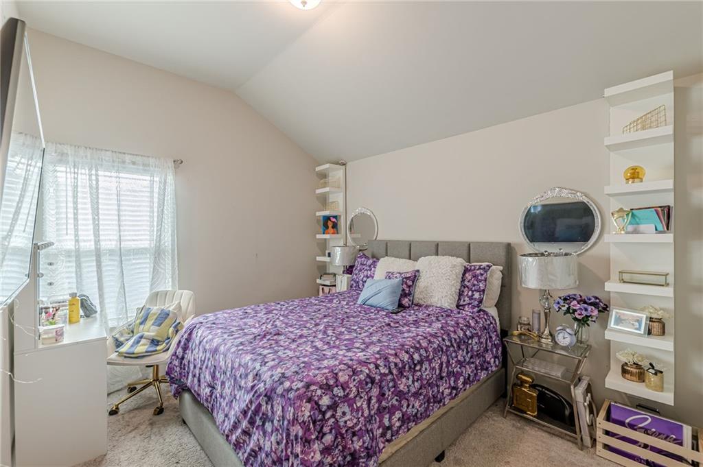 7425 Faith Street Fairburn, GA 30213 - Photo 16 of 29 a bedroom with a bed and a potted plant on the dresser
