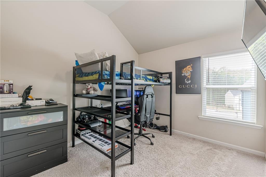 7425 Faith Street Fairburn, GA 30213 - Photo 19 of 29 a bedroom with furniture a air conditioner and a window