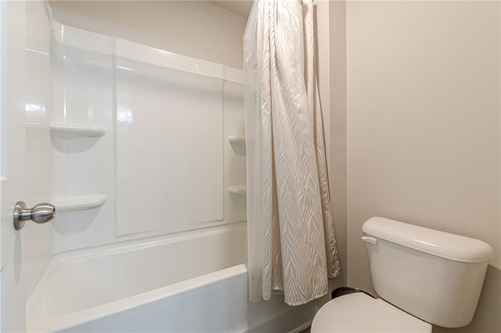 7425 Faith Street Fairburn, GA 30213 - Photo 20 of 29 a white toilet sitting next to a bath tub