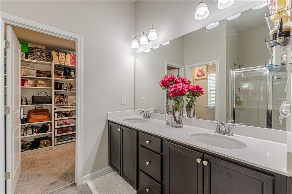 7425 Faith Street Fairburn, GA 30213 - Photo 24 of 29 a bathroom with a sink vanity and a mirror