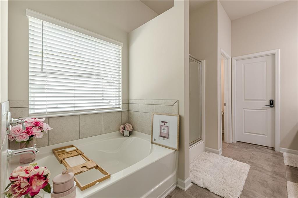 7425 Faith Street Fairburn, GA 30213 - Photo 25 of 29 a bath room with a bathtub and a window