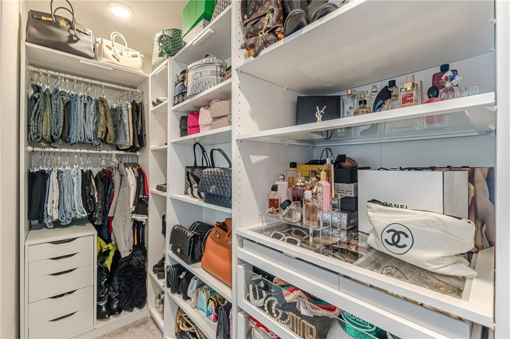 7425 Faith Street Fairburn, GA 30213 - Photo 26 of 29 a view of walk in closet with clothes and shoes