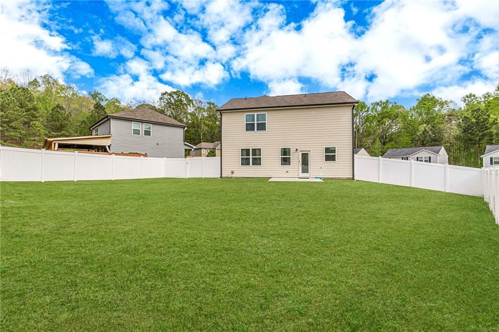 7425 Faith Street Fairburn, GA 30213 - Photo 28 of 29 a view of a house with a back yard