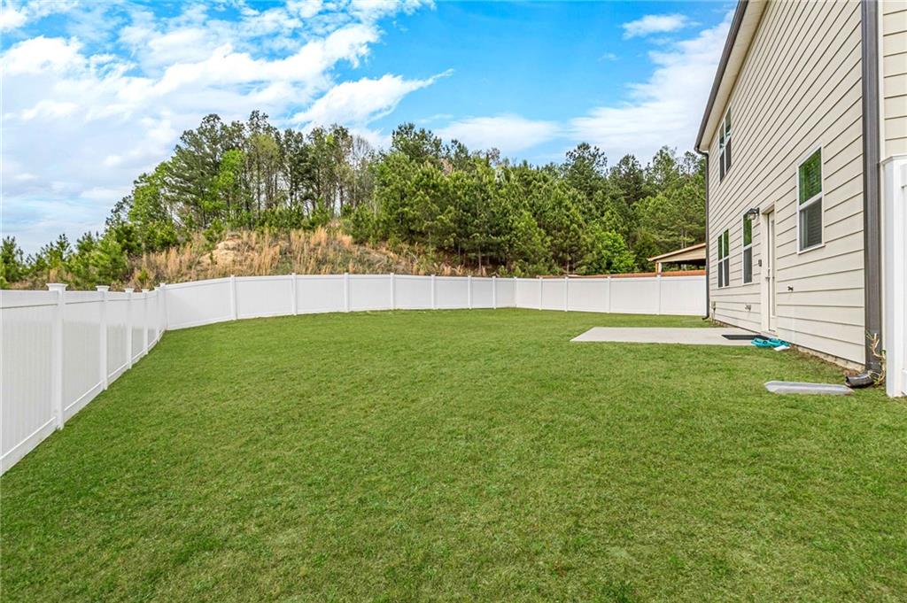7425 Faith Street Fairburn, GA 30213 - Photo 29 of 29 a view of a backyard with a garden
