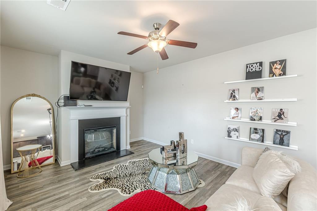 7425 Faith Street Fairburn, GA 30213 - Photo 8 of 29 a living room with furniture and a fireplace