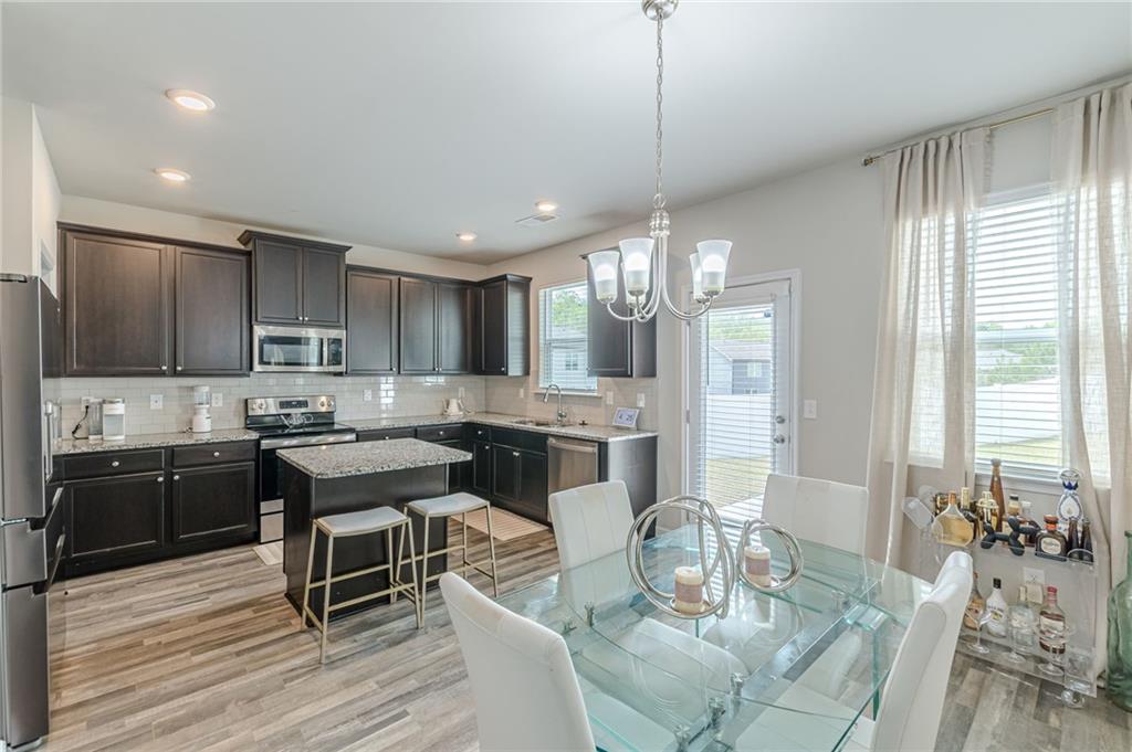 7425 Faith Street Fairburn, GA 30213 - Photo 9 of 29 a large kitchen with a table and chairs