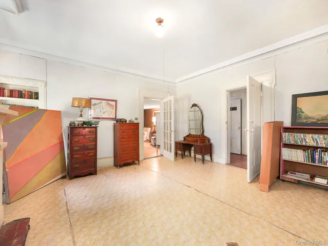 a bedroom with furniture and a book shelf