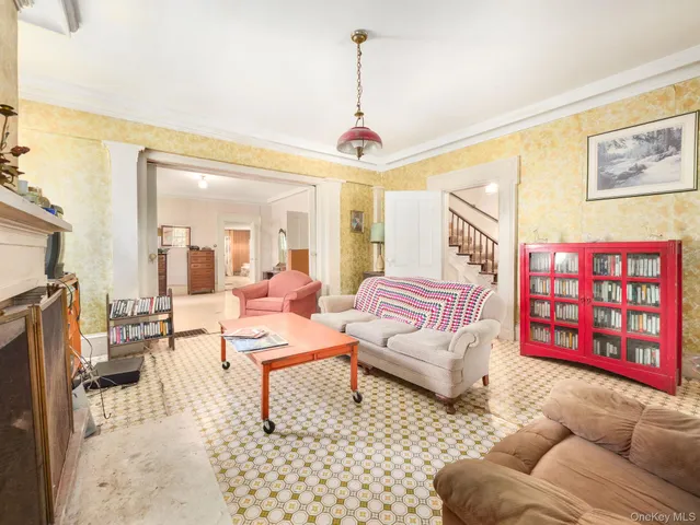 a living room with furniture a rug and white walls