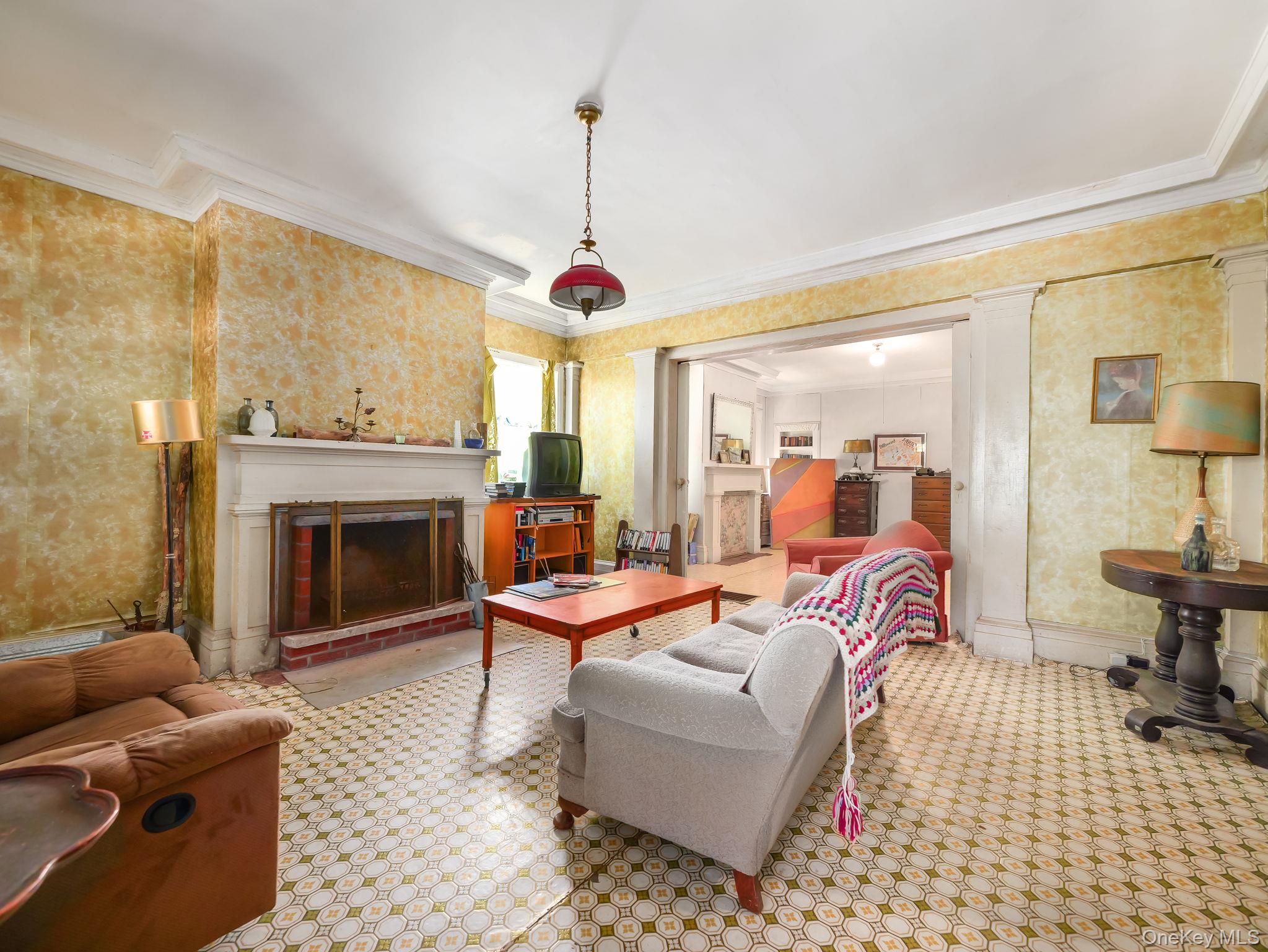 19 Oakland Valley Road Cuddebackville, NY 12729 - Photo 16 of 30 a living room with furniture a fireplace and a chandelier