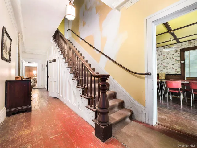 a view of entryway and hall with wooden floor