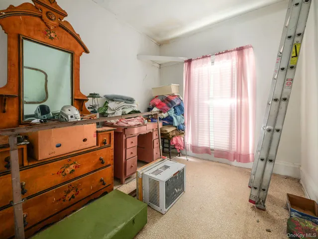 a room with a dresser and a window