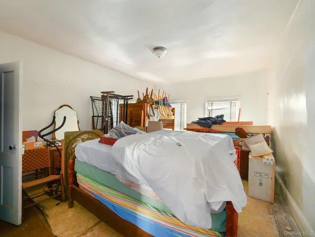 a bed room with a bed and a chair