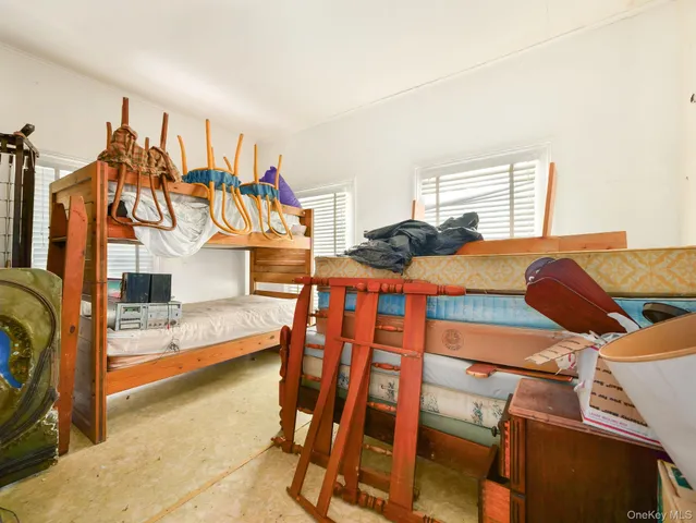 a bedroom with furniture and a window