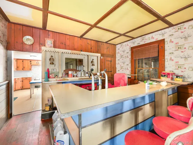 a view of a room with chairs and kitchen view