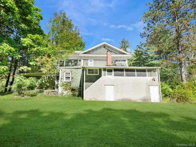 a house with green field in front of it