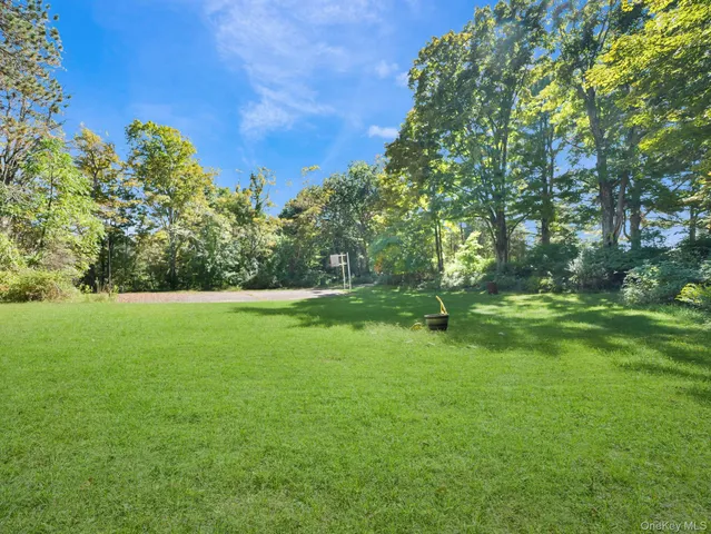 a view of field with trees in the background