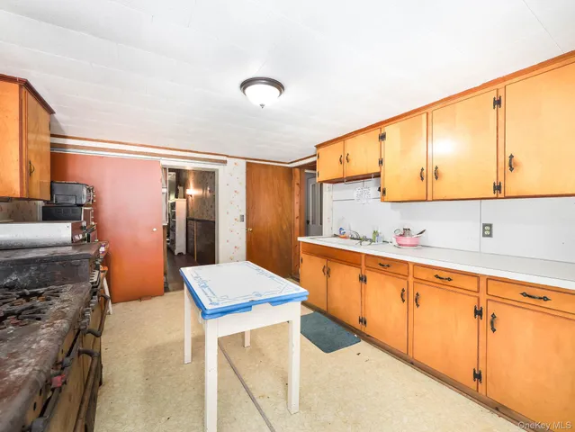 a kitchen with stainless steel appliances kitchen island granite countertop a sink and cabinets