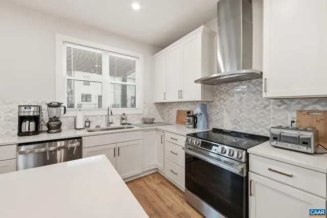 a kitchen with stainless steel appliances a refrigerator sink and stove
