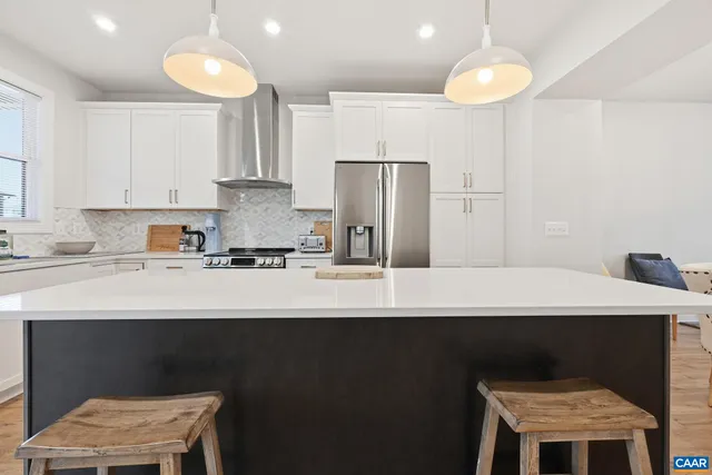 a stove top oven sitting inside of a kitchen