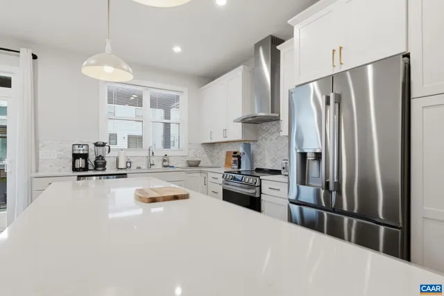 a kitchen with a dining table chairs sink and cabinets