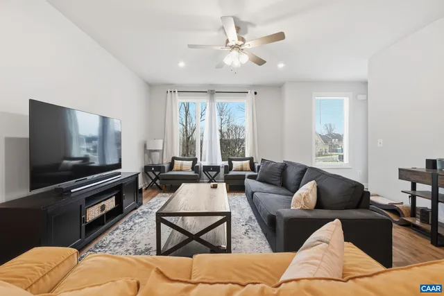 a balcony with wooden floor a ceiling fan