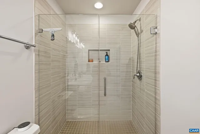 a large bed sitting in a bedroom next to a window