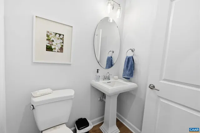 a kitchen with kitchen island a counter top space a sink stainless steel appliances and cabinets