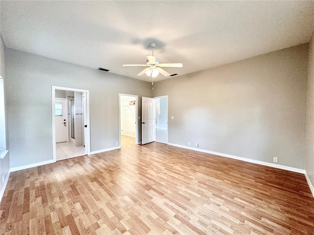 16 Westbrook Lane Palm Coast, FL 32164 - Photo 21 of 42 a view of an empty room with chandelier fan and a window