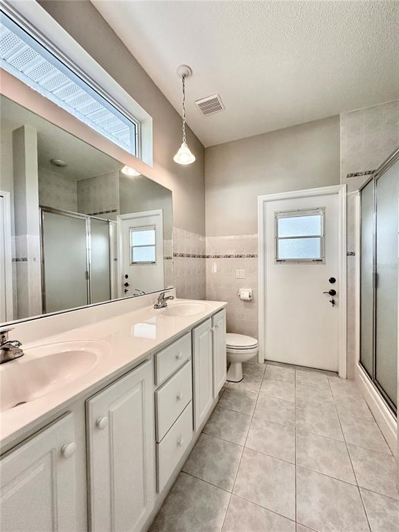 16 Westbrook Lane Palm Coast, FL 32164 - Photo 25 of 42 a spacious bathroom with a granite countertop sink a toilet and a mirror