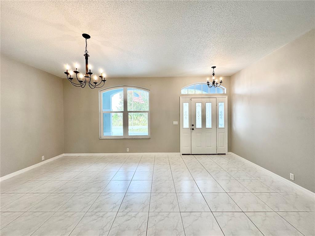 16 Westbrook Lane Palm Coast, FL 32164 - Photo 3 of 42 a view of an empty room with a chandelier
