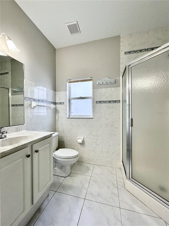 16 Westbrook Lane Palm Coast, FL 32164 - Photo 32 of 42 a bathroom with a granite countertop shower a toilet and a sink