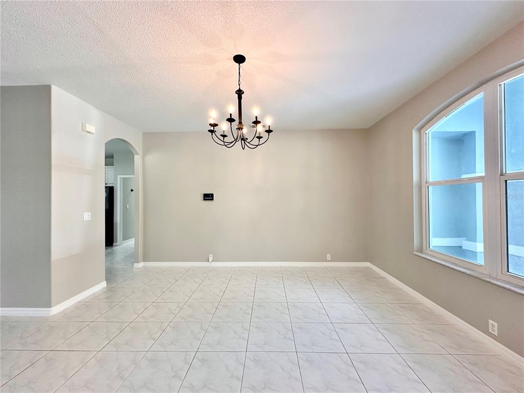16 Westbrook Lane Palm Coast, FL 32164 - Photo 7 of 42 a view of a livingroom with a chandelier fan and windows