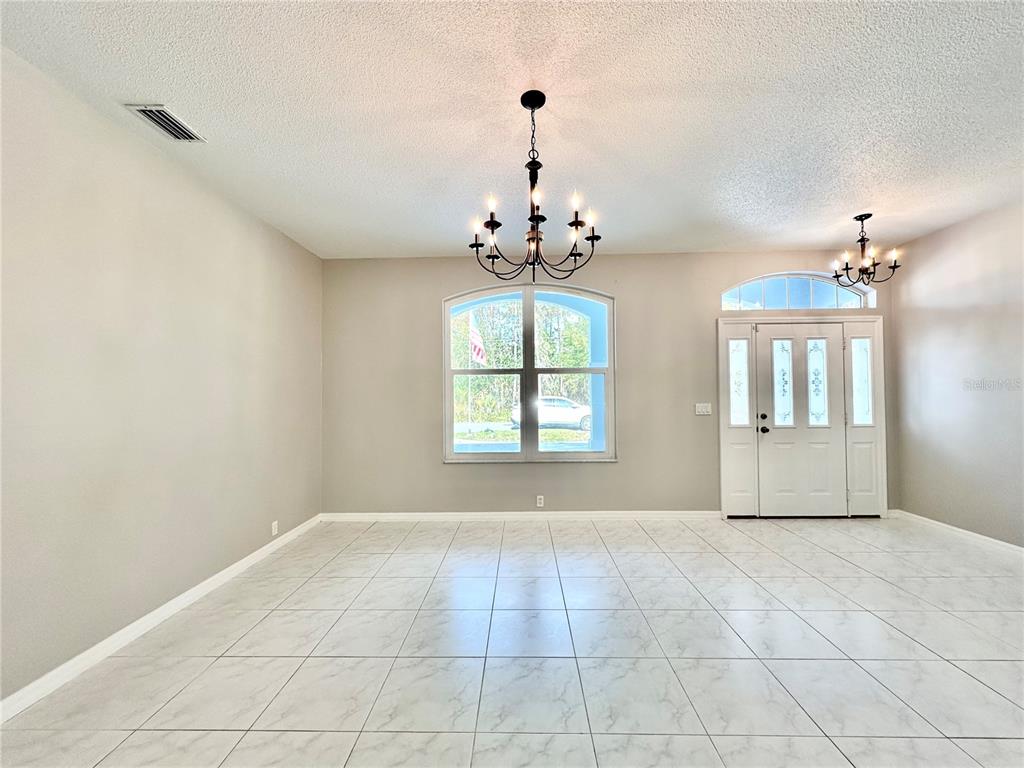16 Westbrook Lane Palm Coast, FL 32164 - Photo 8 of 42 a view of an empty room with a chandelier