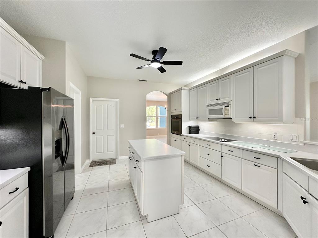 16 Westbrook Lane Palm Coast, FL 32164 - Photo 10 of 42 a kitchen with white cabinets and stainless steel appliances