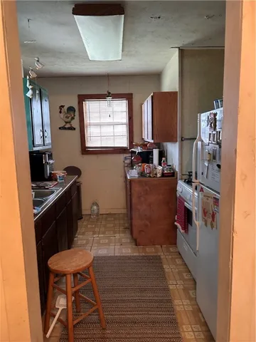 a kitchen with a stove a refrigerator and a dining table