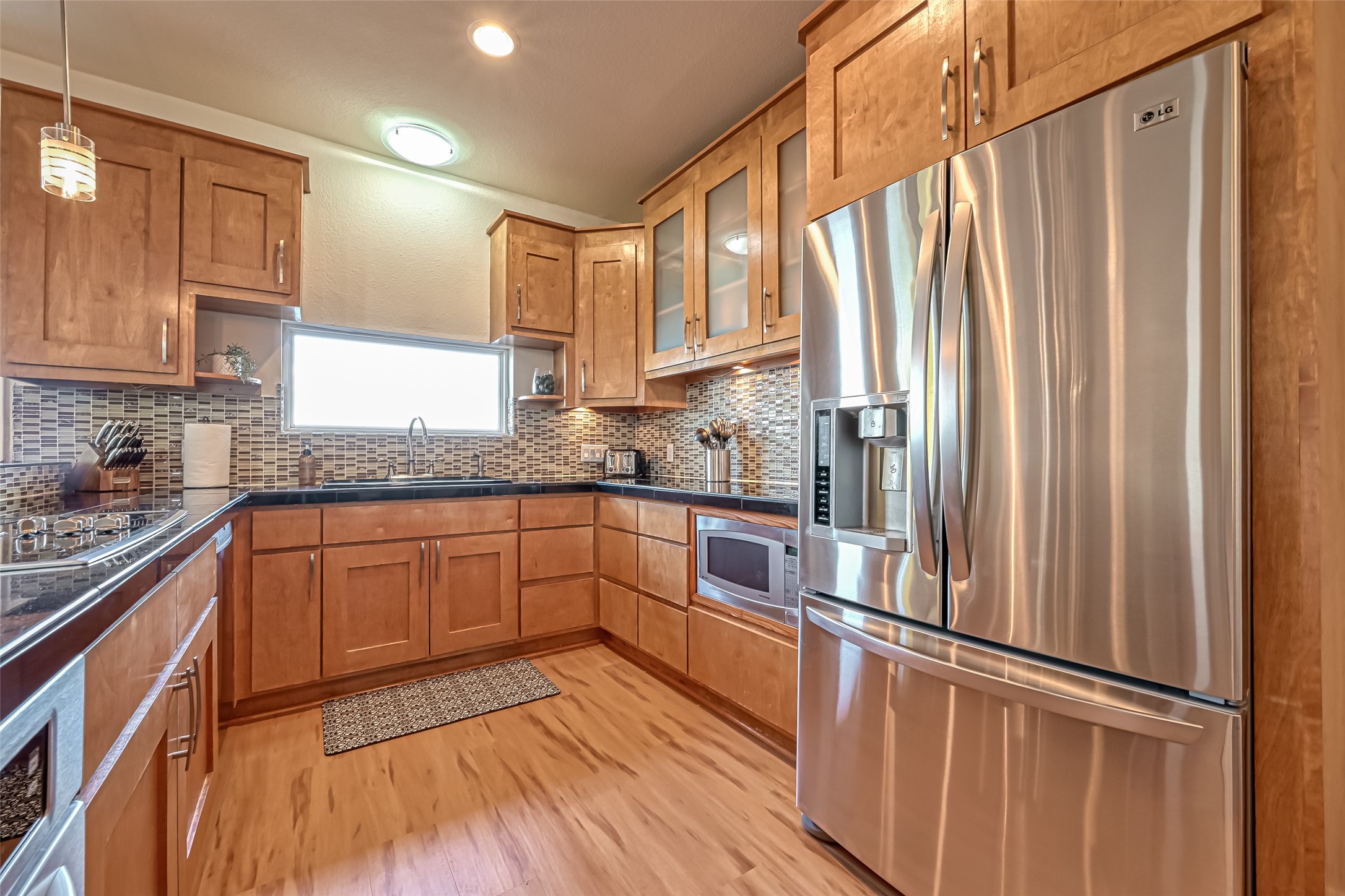 2102 Todville Road, Unit 9 Seabrook, TX 77586 - Photo 11 of 34 a kitchen with stainless steel appliances granite countertop a refrigerator a sink and wooden cabinets