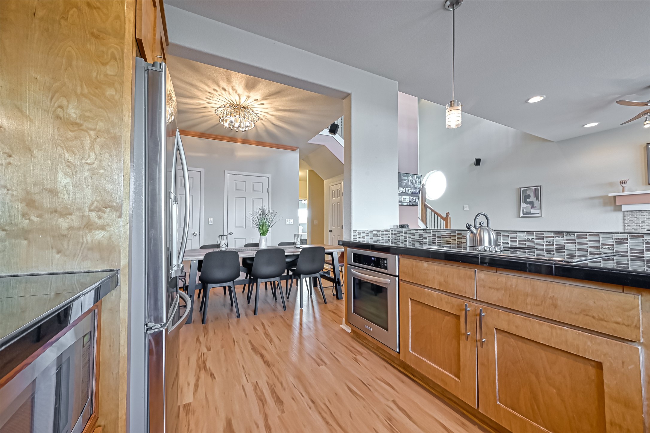 2102 Todville Road, Unit 9 Seabrook, TX 77586 - Photo 13 of 34 a large kitchen with cabinets chairs and wooden floor