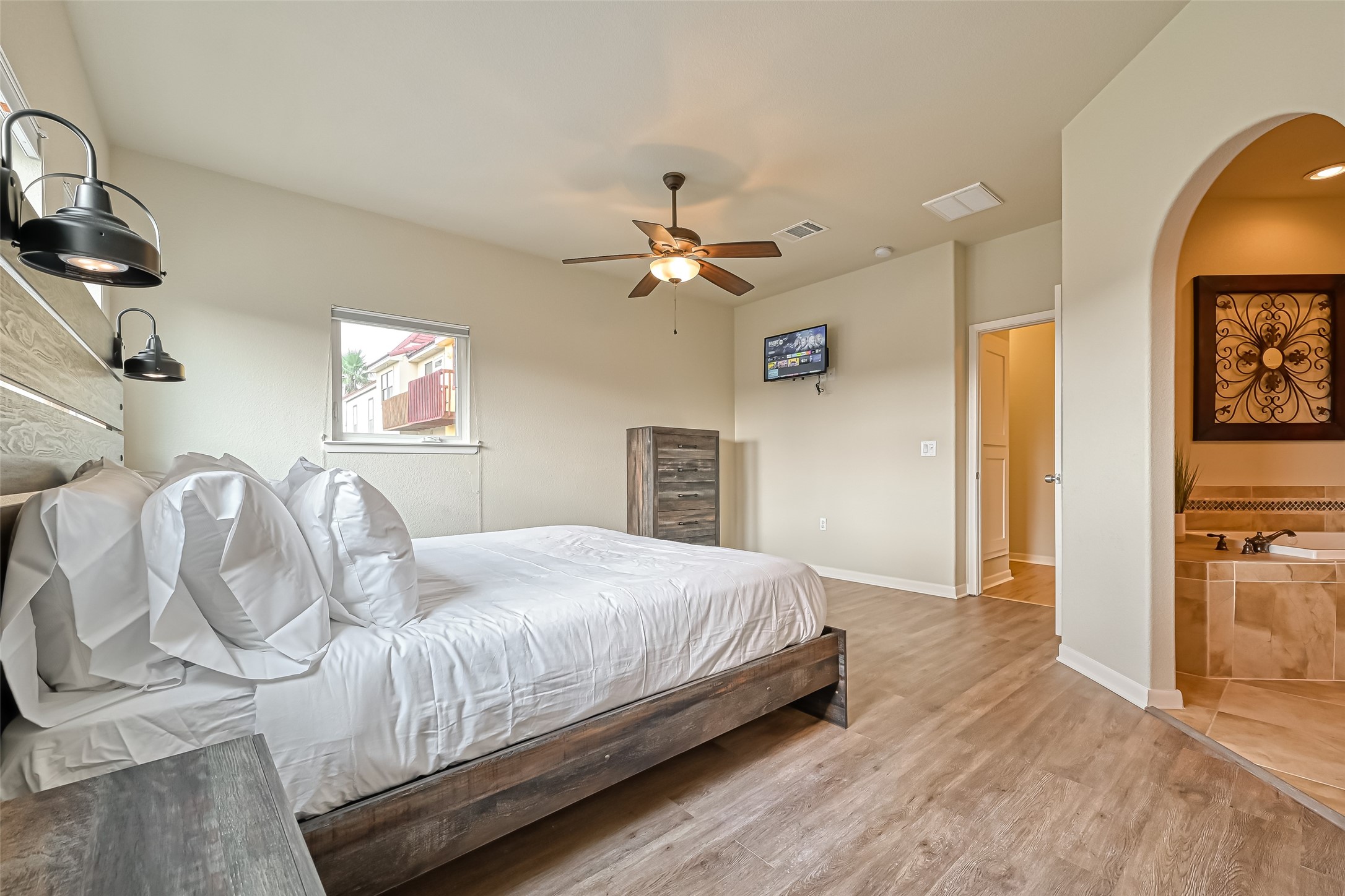 2102 Todville Road, Unit 9 Seabrook, TX 77586 - Photo 16 of 34 a bedroom with bed and a chandelier