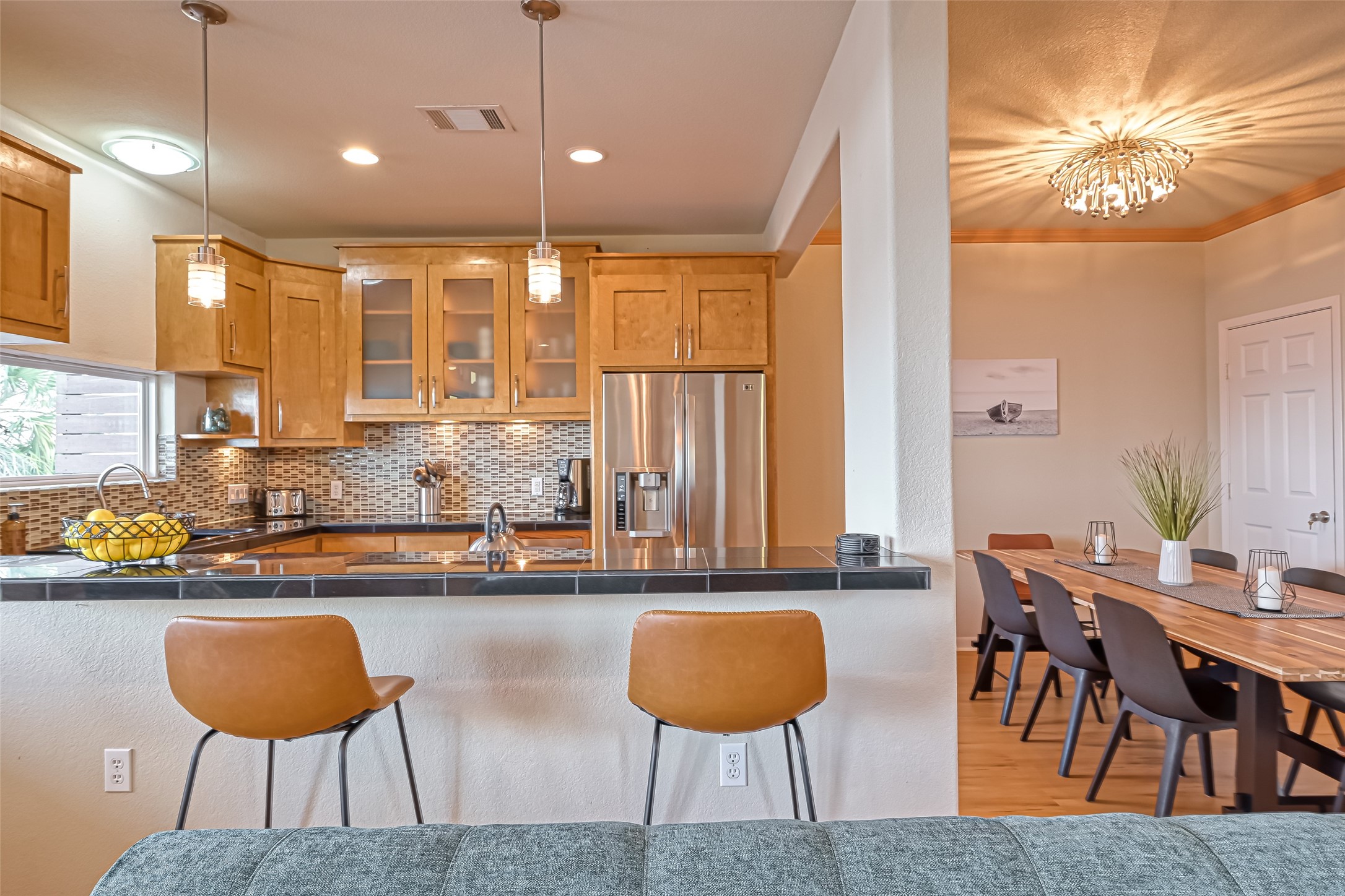 2102 Todville Road, Unit 9 Seabrook, TX 77586 - Photo 7 of 34 a kitchen with stainless steel appliances kitchen island granite countertop a table and chairs