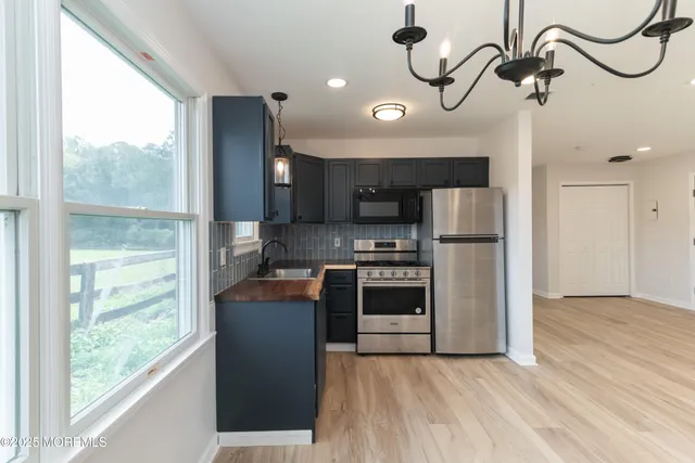 a kitchen with a sink stove and cabinets