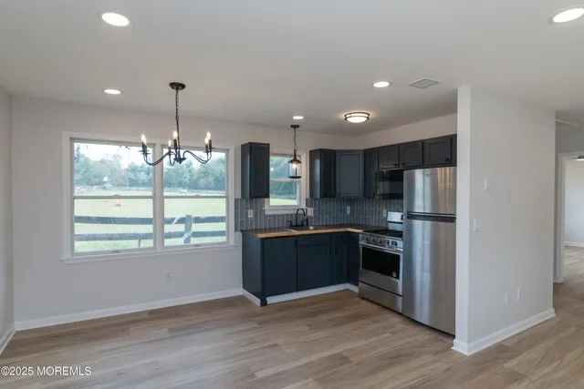 a kitchen with a sink a window and cabinets