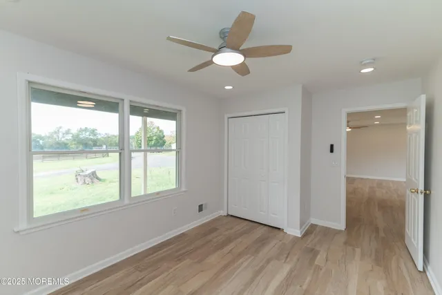 a view of a room with wooden floor and windows