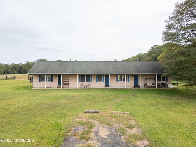 a view of a house with swimming pool and a yard