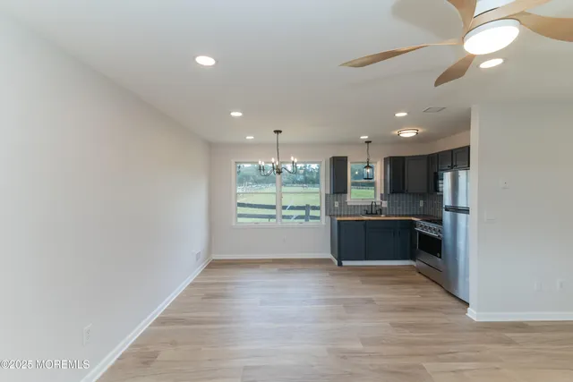 a kitchen with stainless steel appliances kitchen island granite countertop a stove a sink and a refrigerator